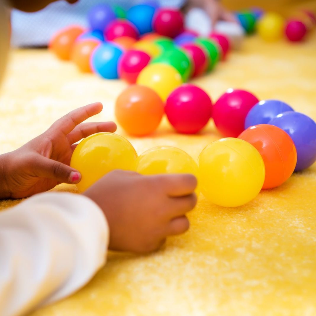 child-playing-with-colored-balls